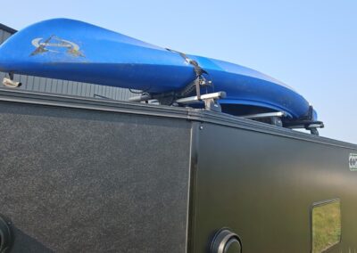 CORE RV 6515 Trailhead rooftop view showing the mounting of a kayak on the rack